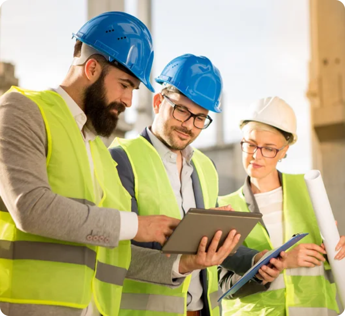 Construction team reviewing digital plans and takeoff quantities on a tablet at a job site.